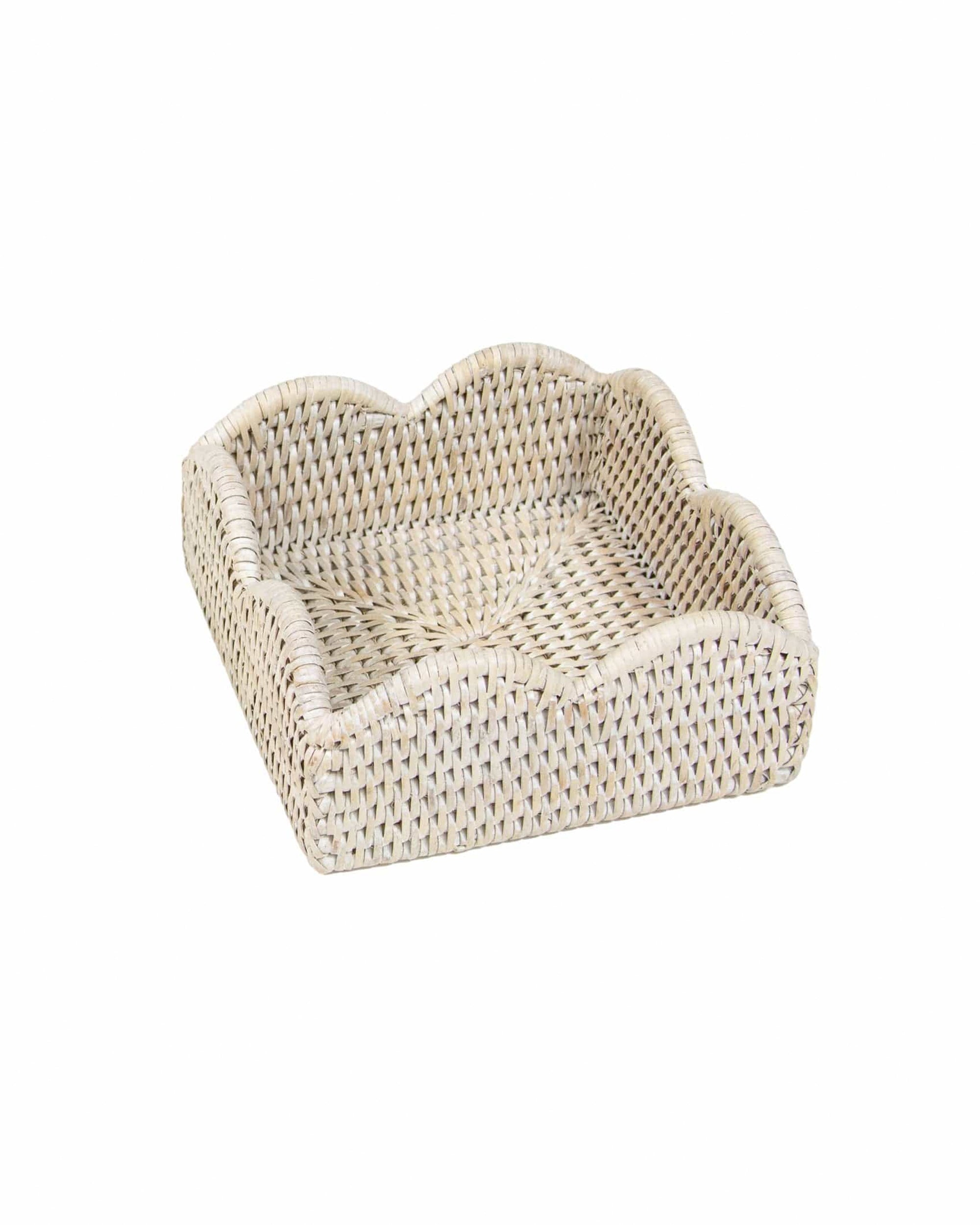 The Caspari, Inc. Rattan Scallop Cocktail Napkin Holder features wavy edges and a light natural finish, adding charming tabletop decor and keeping napkins organized on any surface.