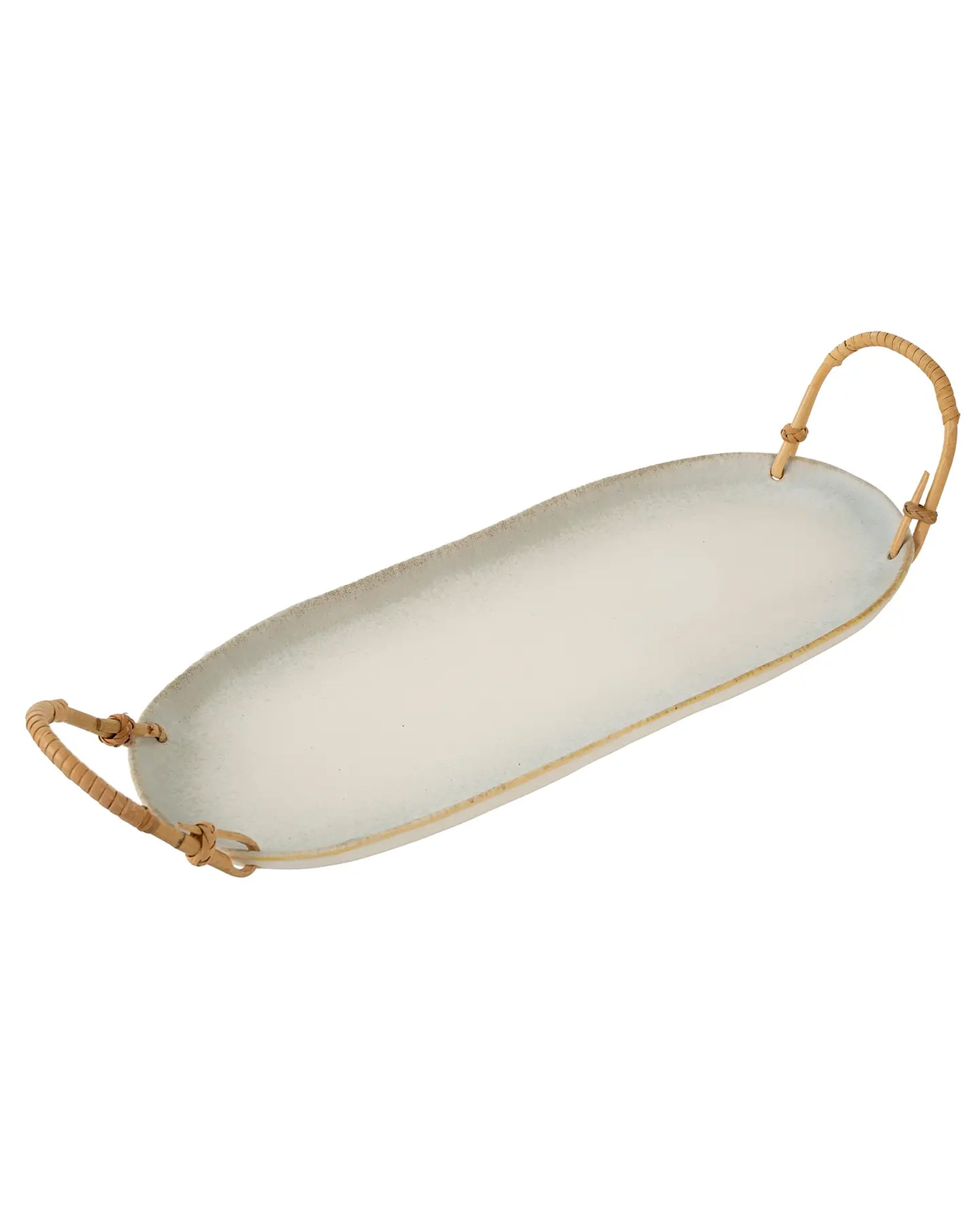 The Faire Rattan Wrapped Ceramic Platter L features an oval, handcrafted design with a speckled glaze, slightly uneven edges, and two rattan-wrapped handles—perfect for stylish serving.