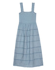 The Reverie Dress by The Great Inc. is a sleeveless light blue cotton midi dress with wide straps, a square neckline, horizontal lace details, a gathered waist, and a scalloped hem. Dry clean recommended.