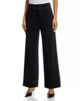 A person wears Rag & Bone's Irina Pont Contrast Stitch Pants—high-waisted, relaxed fit wide-legs with white contrast stitching—paired with a white top and black pointed-toe shoes. The image shows the pants from waist to feet.