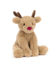 The Romi Reindeer by Jelly Cat Inc. is a soft, light brown plush with dark antlers, round ears, a red nose, and black eyes. Sitting upright against a white background, it’s the perfect Christmas companion for festive joy.