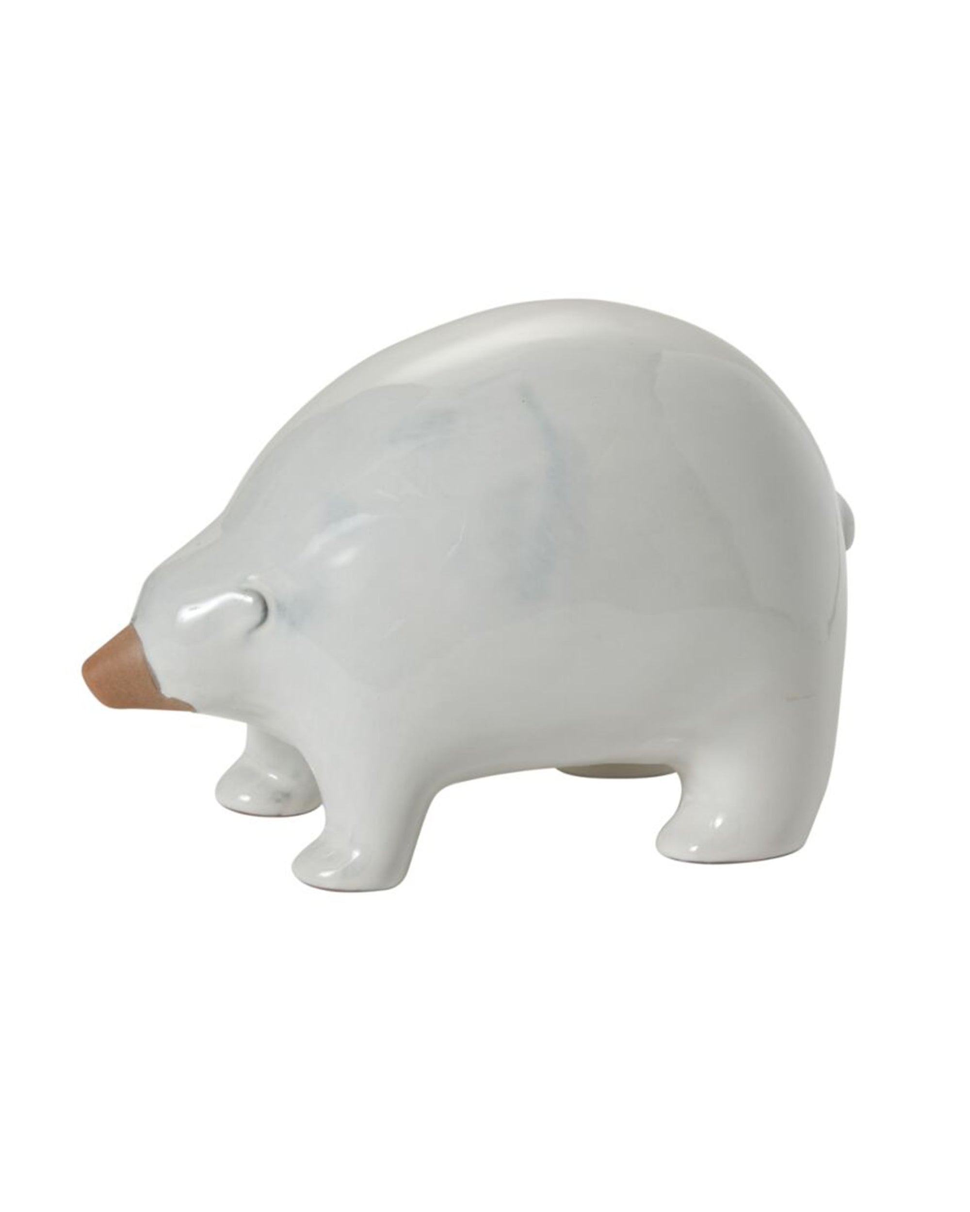 The Ceramic Polar Bear by Accent Decor is a minimalist white figurine with a brown snout, shown in profile on a plain background—a charming piece for any Arctic-inspired collection.