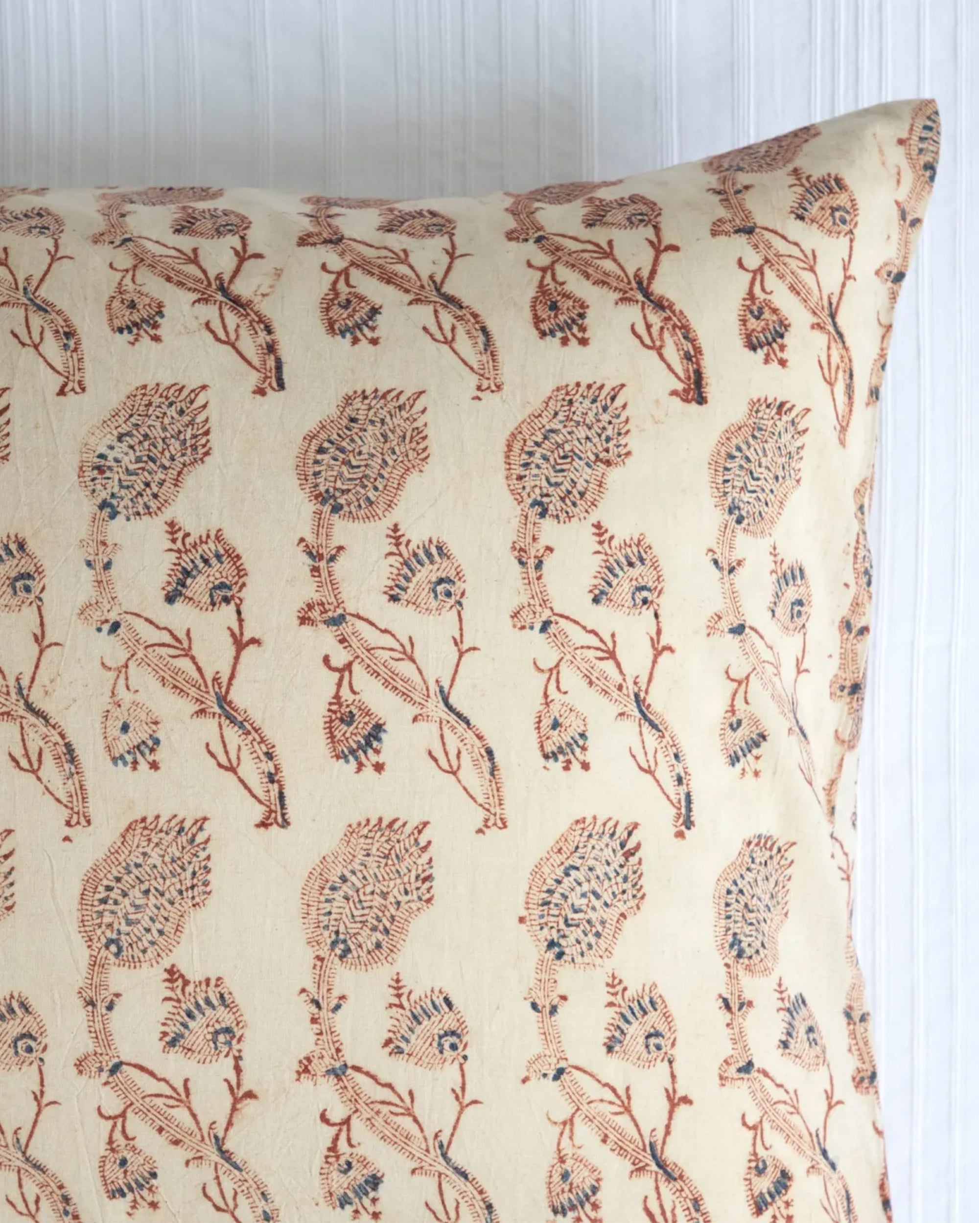 The Les Indiennes Rupa Tan Standard King Pillow Shaw features a pure cotton beige cover with red and blue floral patterns, set against a white background with vertical lines.