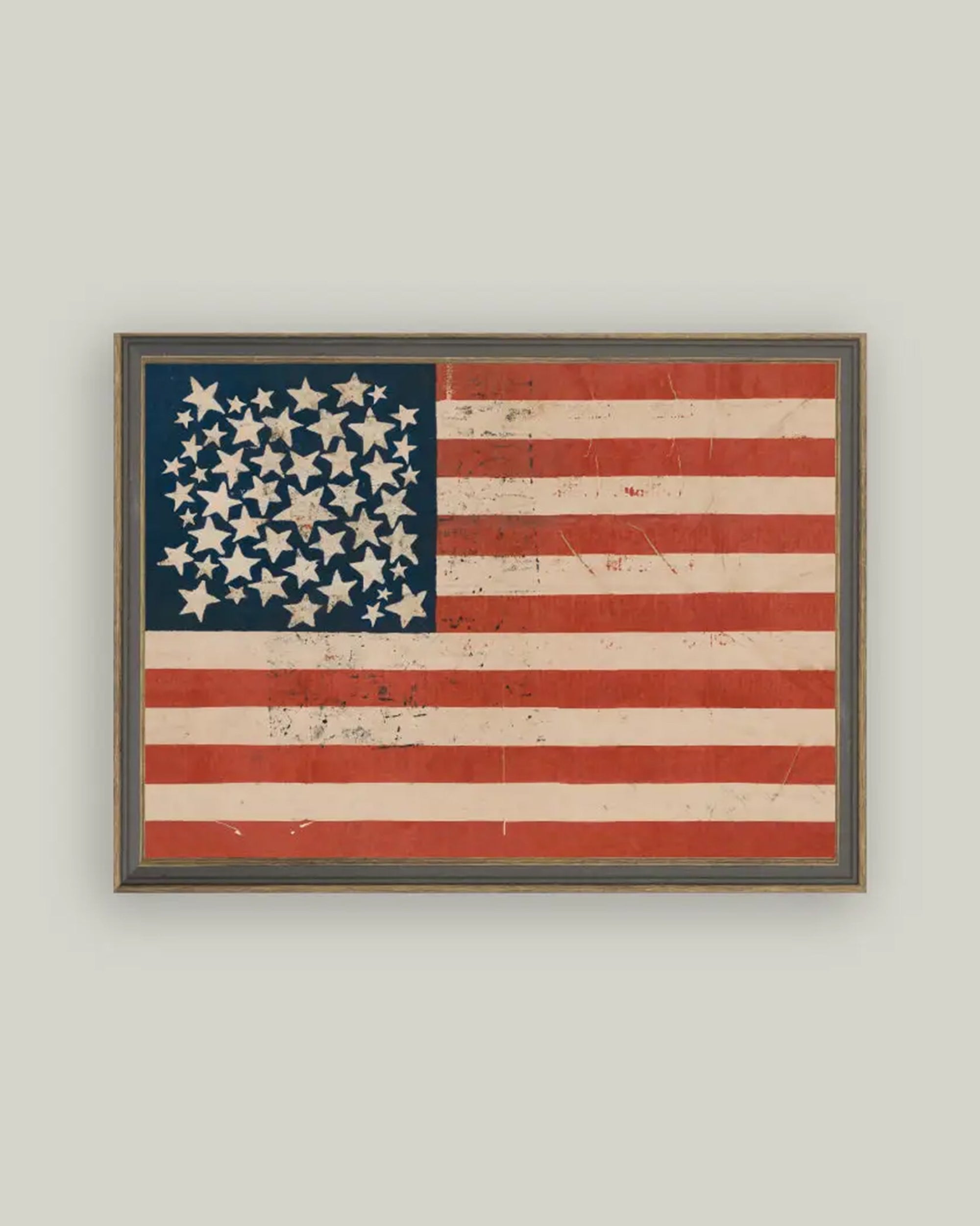 The Rustic Flag Framed Art by Petal Lane Home showcases a vintage-style American flag with clustered stars and faded stripes, presented on premium canvas in a handcrafted ornate frame. Made in the USA.