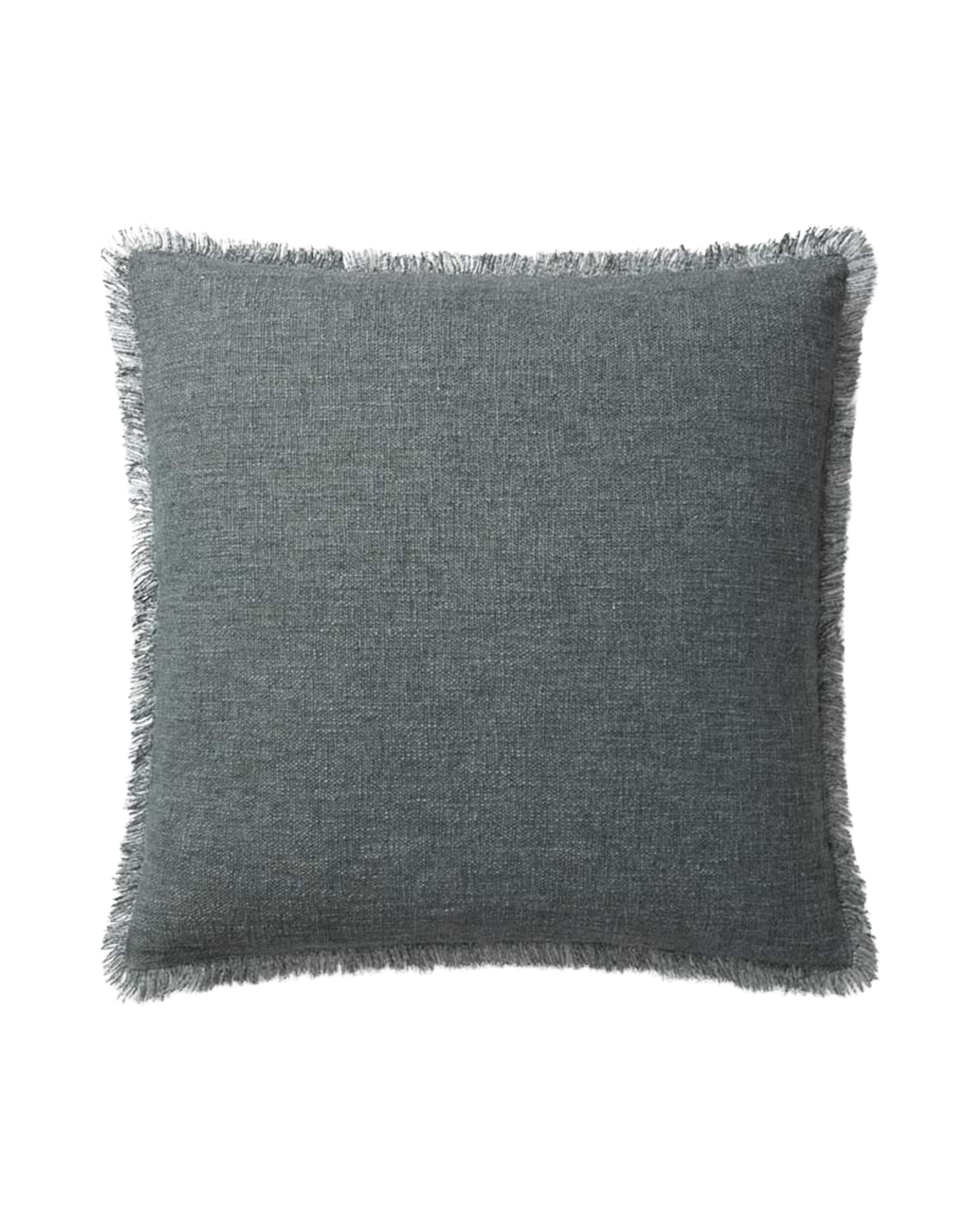The Sable Blue 22x22 pillow by Loloi Rugs features a subtle machine-woven texture, hidden flap zipper, and fringe edges, shown on a plain white background.