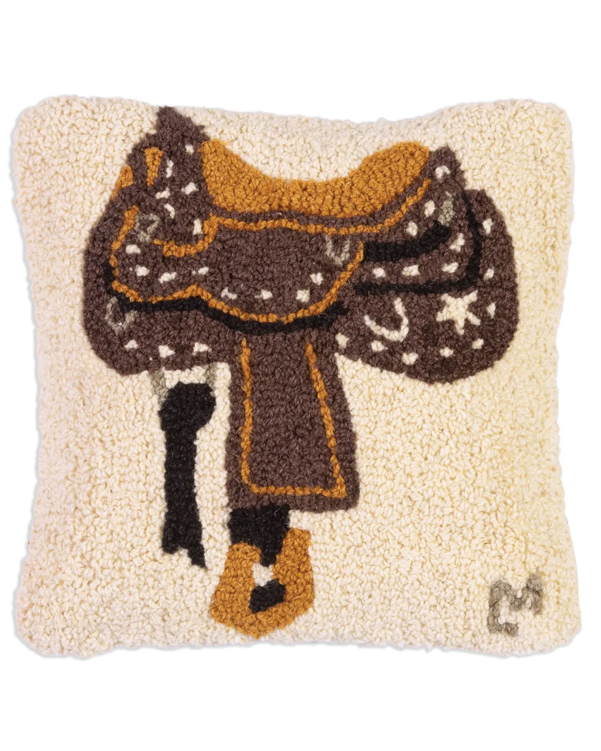 The Faire C4C Western Saddle Pillow 14x14 is a square, cream-colored, hand-hooked wool pillow featuring a brown and gold western saddle with decorative patterns and a small stylized “M” in the lower right corner.