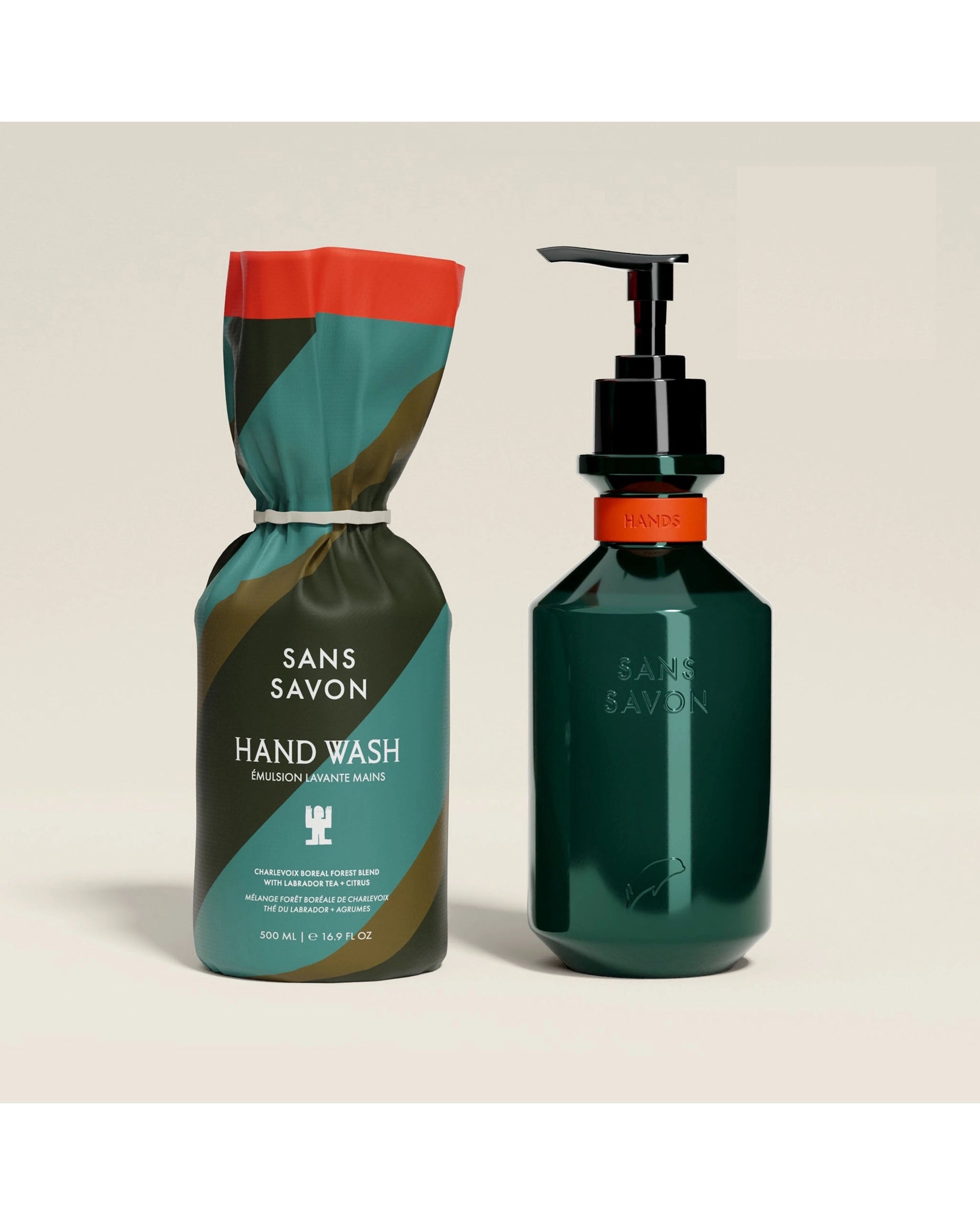 Two bottles of Faire’s Hand Wash Charlevoix Boreal—made with upcycled ingredients—stand out: one in vibrant green, black, and orange packaging, the other a green pump dispenser labeled "Hande," both against a plain light background.