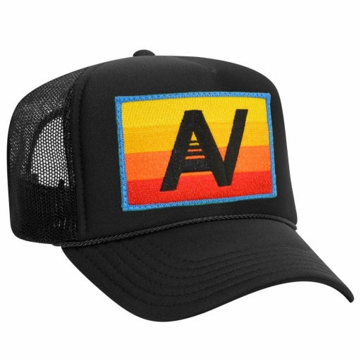 A black mesh baseball cap from Aviator Nation, featuring a vintage low-rise trucker style and a vibrant patch on the front with an orange and yellow gradient background and the bold black letters "AV.