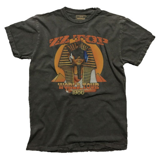 Crafted by Wildcat Retro Brands, this vintage washed tee is made in the USA and features a black T-shirt design with a graphic depicting a pharaoh wearing sunglasses and headphones. It boldly displays the text "ZZ TOP WORLD TOUR 1986.