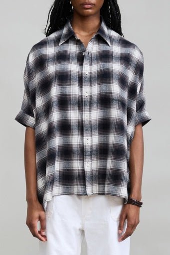 Denimist EMMA black and white plaid shirt styled with white pants, simple background, for Bungalow Furniture &amp; Accessories.