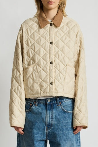 A person wears the Denimist FAULKNER QUILTED JACKET in cream with a brown collar and blue jeans, standing against a plain white background.