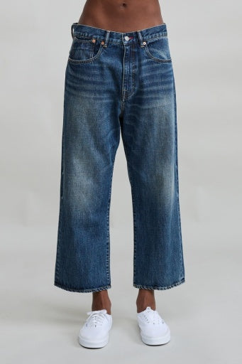 Denimist Haisley Slouch Boyfriend jeans in Sloane Indigo with white sneakers, minimal light background.