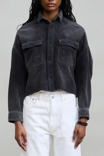 Denimist cropped black cord utility shirt styled with white pants, modern and confident look.
