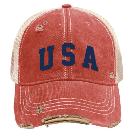 The USA HAT by Wildcat Retro Brands features a classic snapback trucker style, highlighted by its aged red front with beige mesh back and distressed embroidery, prominently displaying the bold blue letters "USA" on the front.