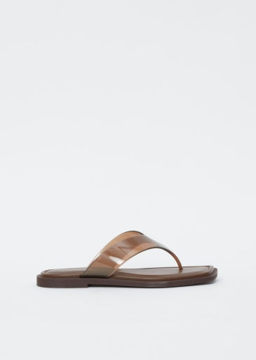 The Rag &amp; Bone gracie jelly thong, a brown sandal with a flat sole and glossy wide strap, features a geometric square toe and is displayed against a plain white background.