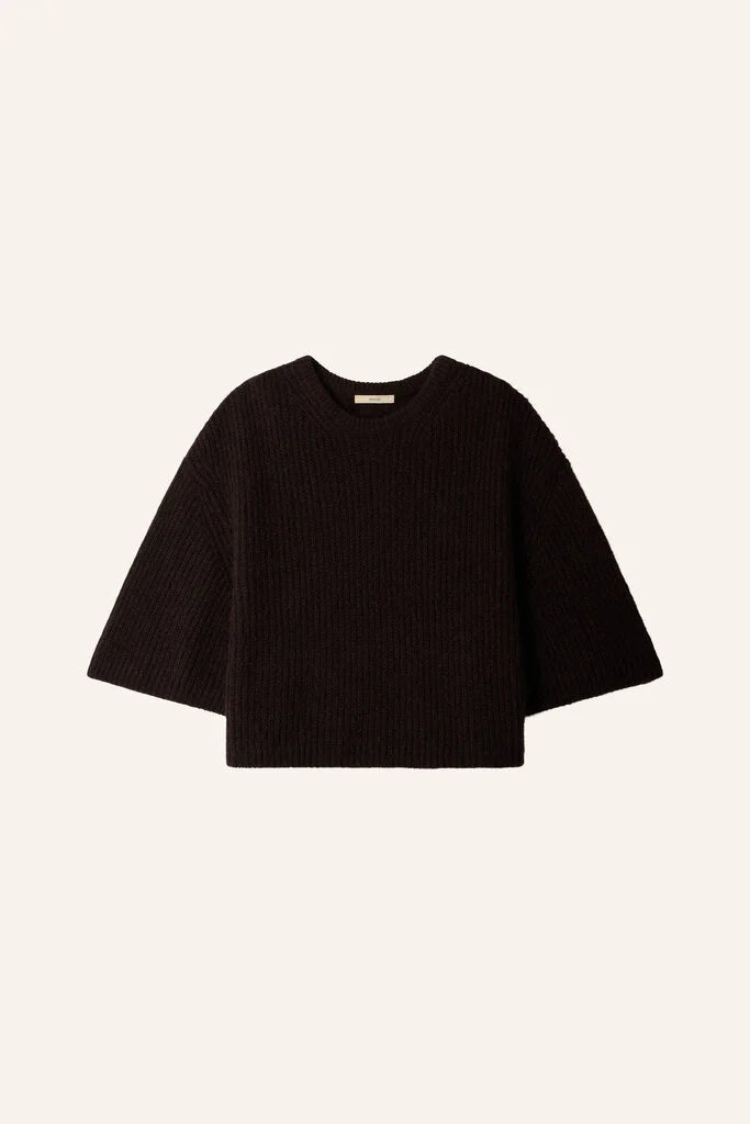 Black ribbed knit sweater with wide sleeves by Sessun, Tallon style, shown on an off-white background.