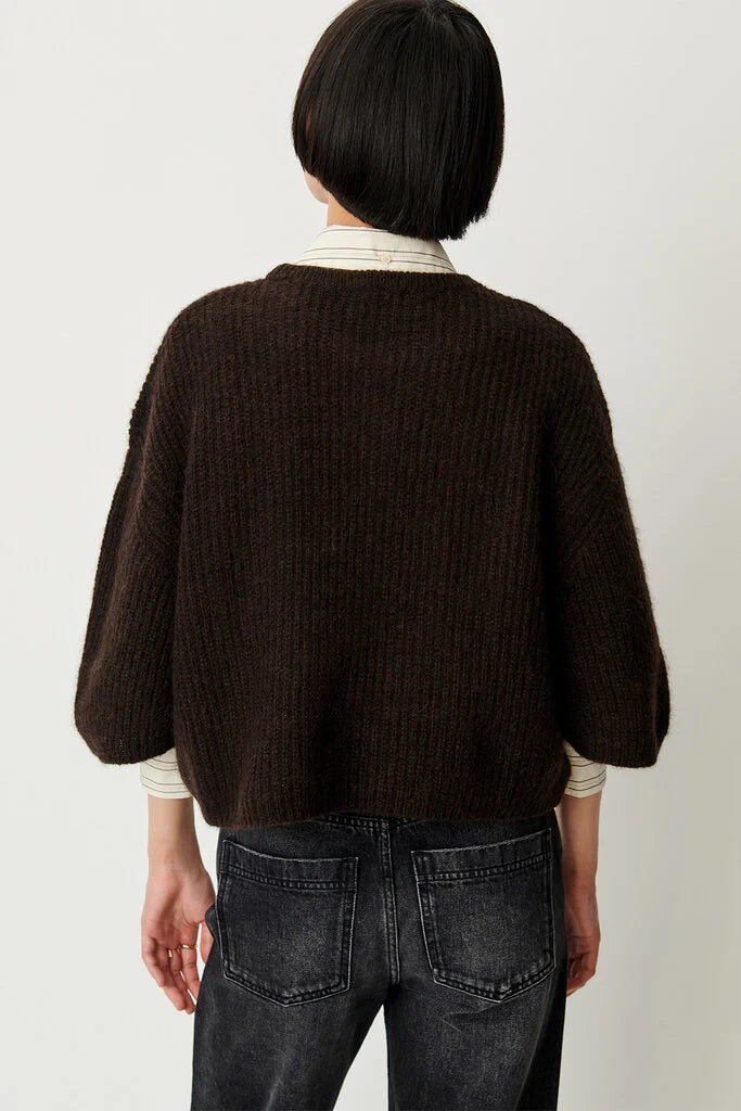 Sessun Tallon dark brown long sleeve sweater styled with black jeans, modern casual look.