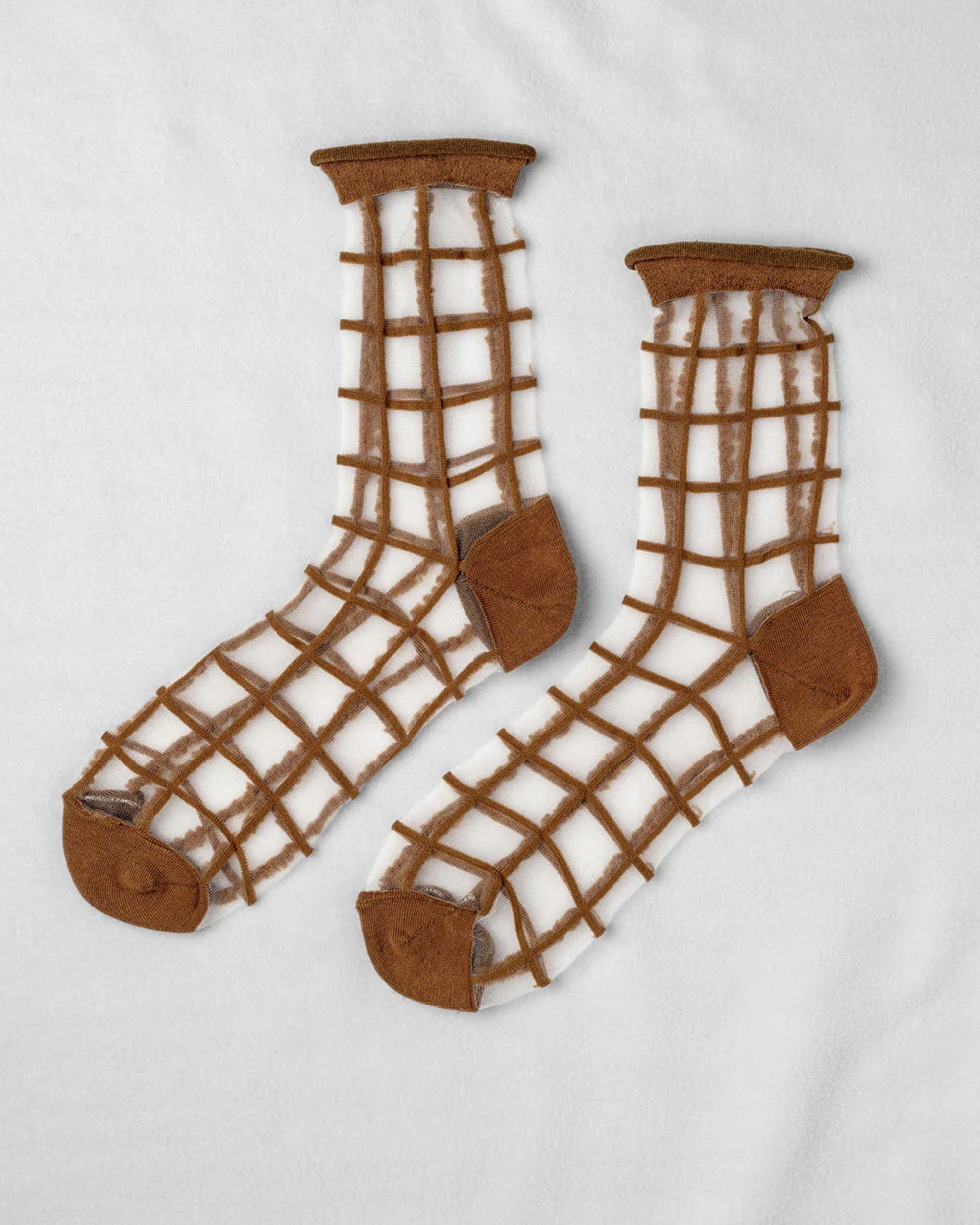 The Unified Sheer French Window socks feature a brown, grid-style net pattern with solid brown toe, heel, and cuffs, shown on a white background.