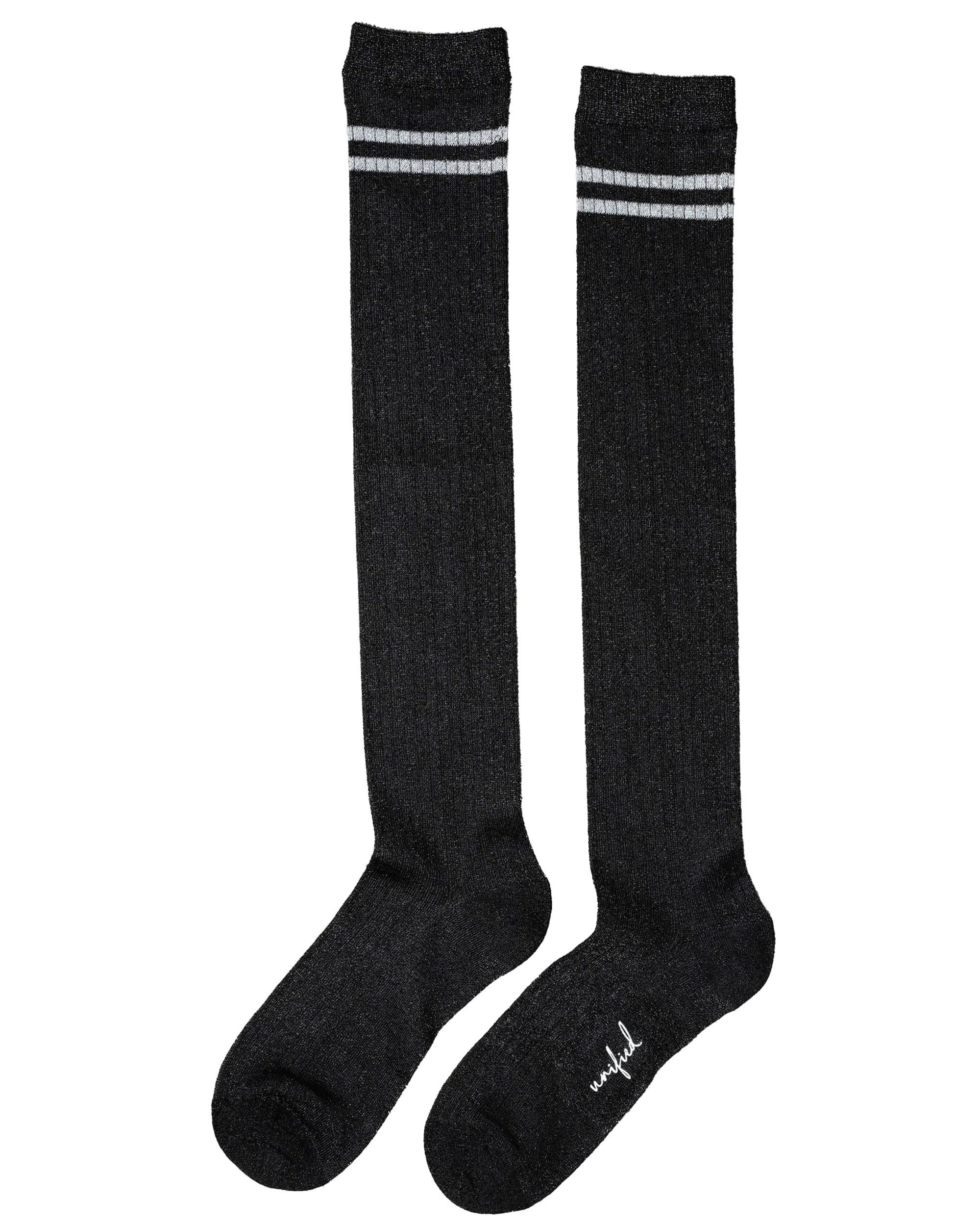 The Unified Shimmer Socks are long, ribbed black knee-highs featuring two white stripes near the top and subtle white text by the toe on one sock.