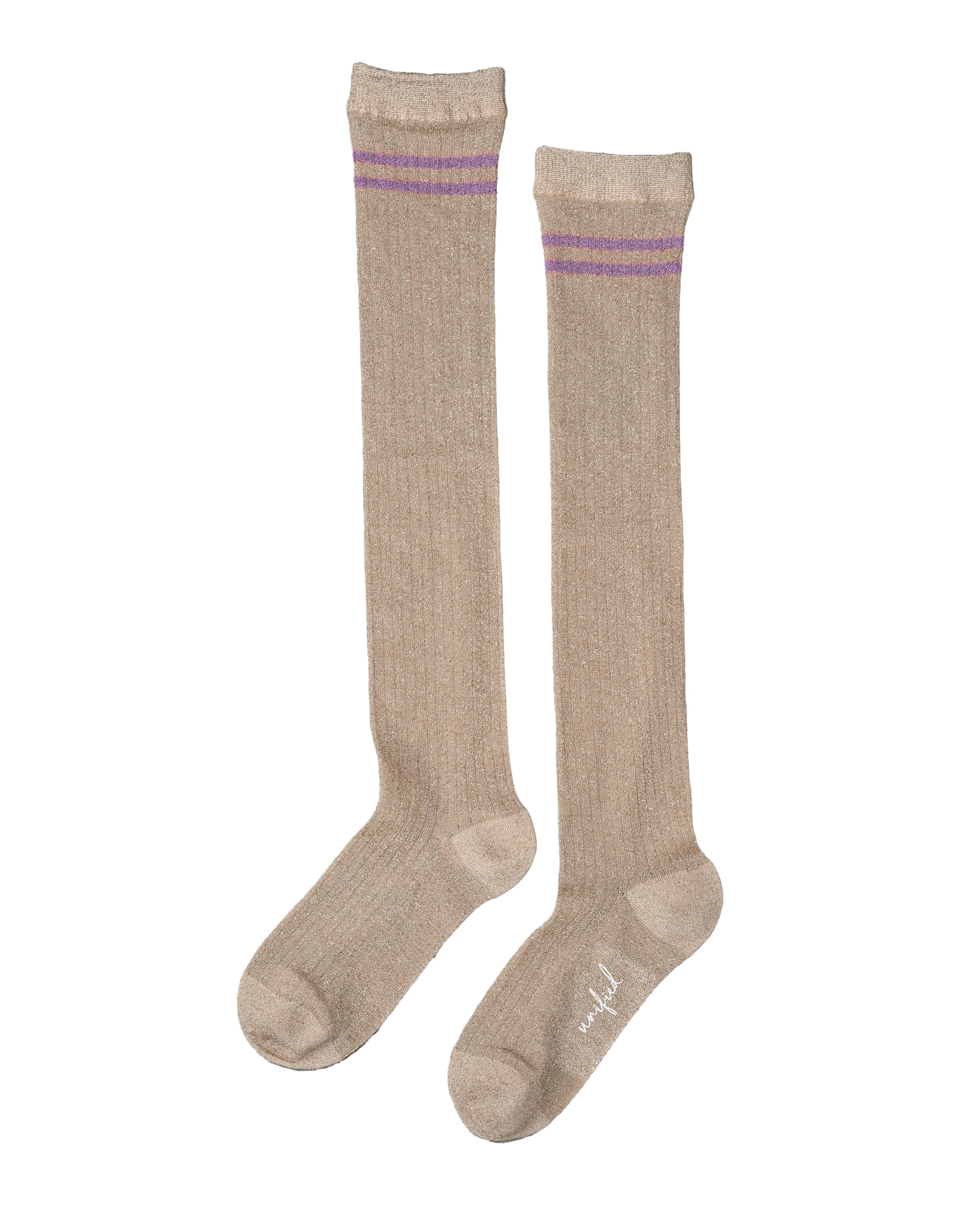 The Unified Shimmer Socks are knee-high beige socks with two horizontal purple stripes near the top, shown laid flat side by side on a white background—ideal for adding a classic touch to any outfit.