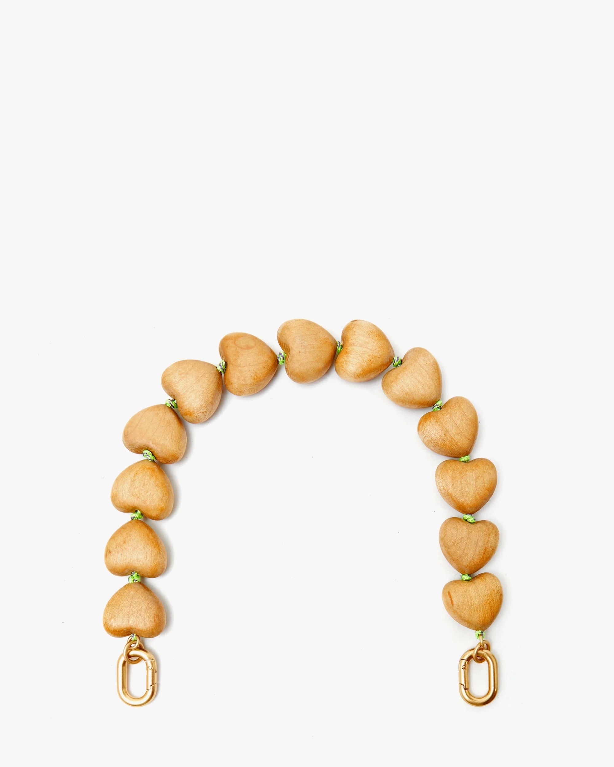 The Clare Vivier Shortie Strap/Heart features light brown, heart-shaped wooden beads strung with neon yellow thread and finished with gold clasps at each end, shown against a white background.