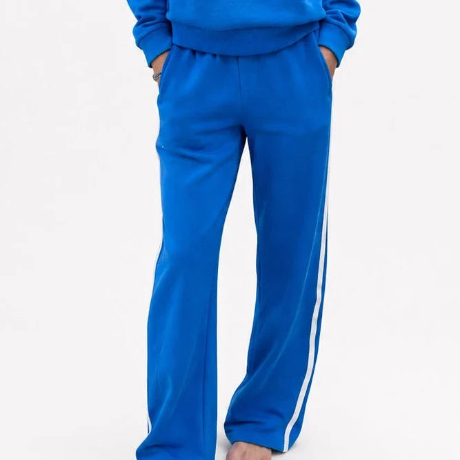 Bright blue fleece palazzo pants with white sporty stripes, Kerri Rosenthal, relaxed weekend lounge style.
