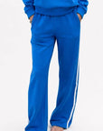 Bright blue fleece palazzo pants with white sporty stripes, Kerri Rosenthal, relaxed weekend lounge style.