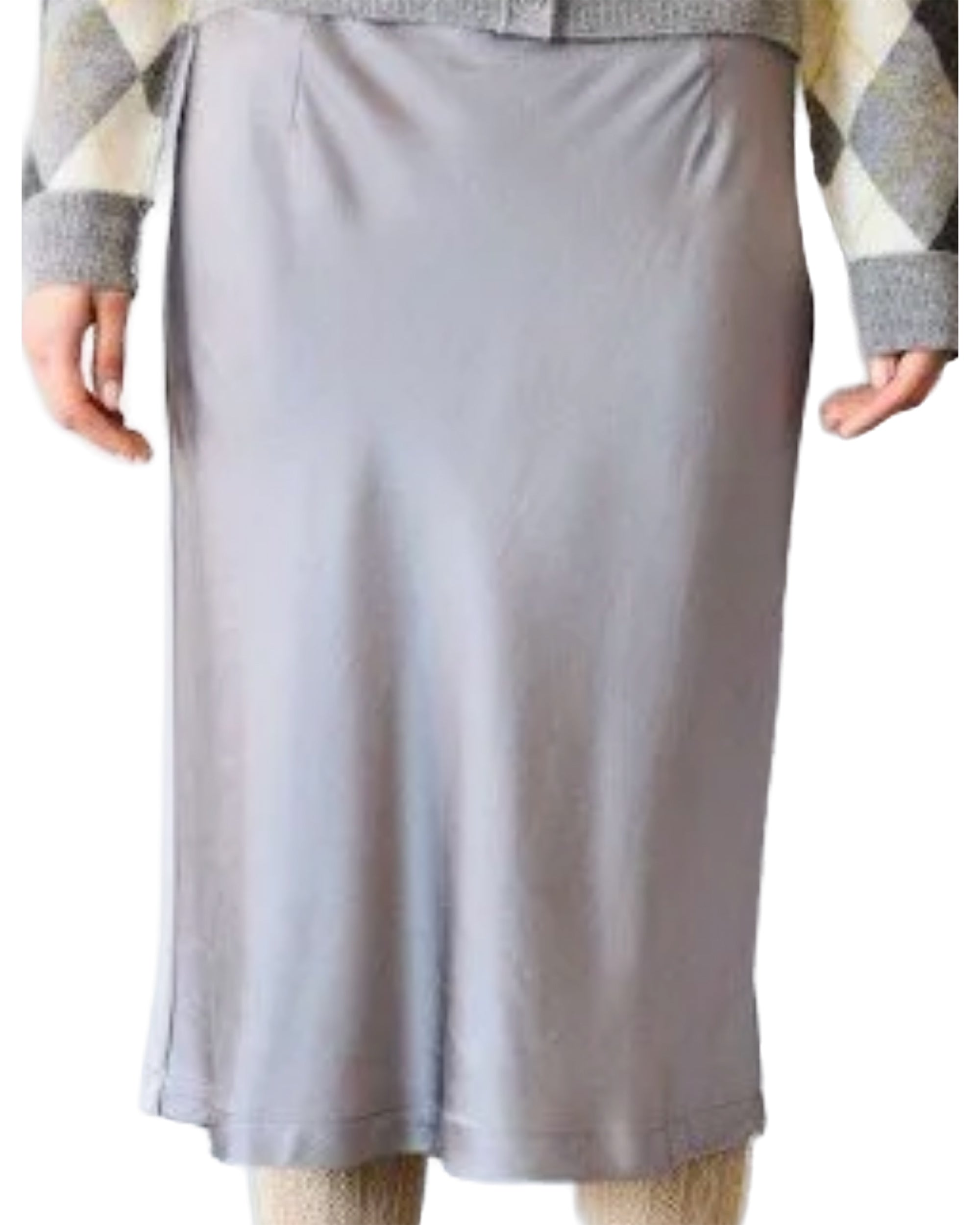 A person is shown from the waist down wearing the Brazeau Tricot Silk Lady Skirt in light gray satin, paired with a beige and gray diamond-patterned sweater.