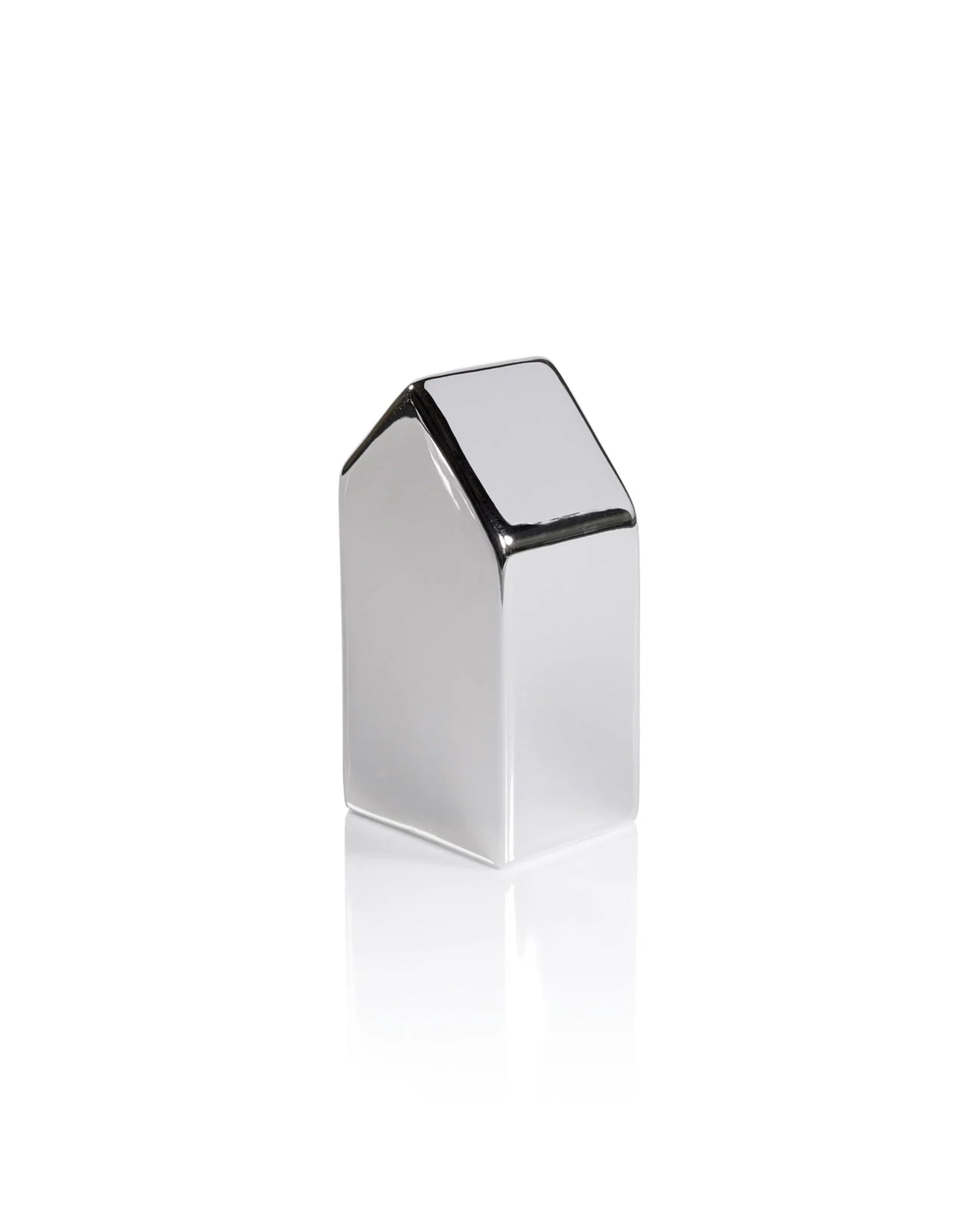 The Zodax Ceramic House Silver XL is a shiny, decorative ceramic home with a slanted roof, displayed on a white background with a reflection—perfect for adding silver charm to your holiday decor.