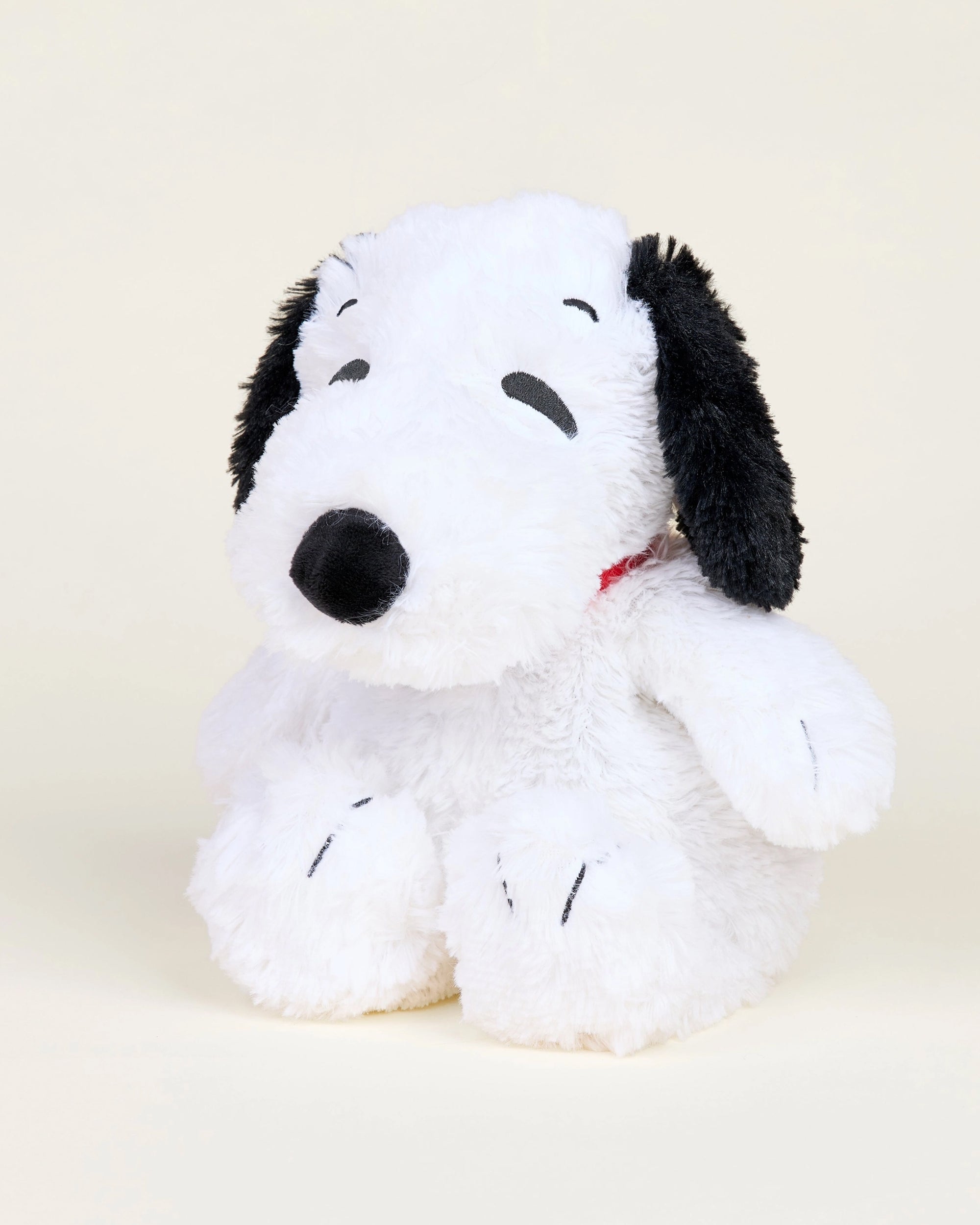 The Warmies/Intelex Snoopy / Red Collar Warmies is a microwavable plush toy of Snoopy, the iconic white dog with black ears and nose, featuring soft, fluffy fabric for comforting sensory support.