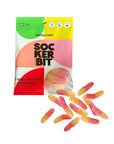 A colorful Faire "Sockerbit Swedish Candy" bag holds sour gummy worms in strawberry lemon flavor, with red and yellow sugar-coated candies shown in front.