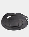 The Global Views Spiral Plate Black features a modern, layered design with a handle-like curve and rich black glaze, displayed against a plain white background.