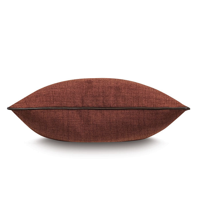 A side view of the Eastern Accents EQUESTRAIN clay-red pillow with a central seam, set against a white background—an elegant decorative accent for stylish interiors.