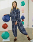 Hunter Bell NYC Briggs Pant in a colorful, artistic indoor setting with playful stacked paper ball sculptures.