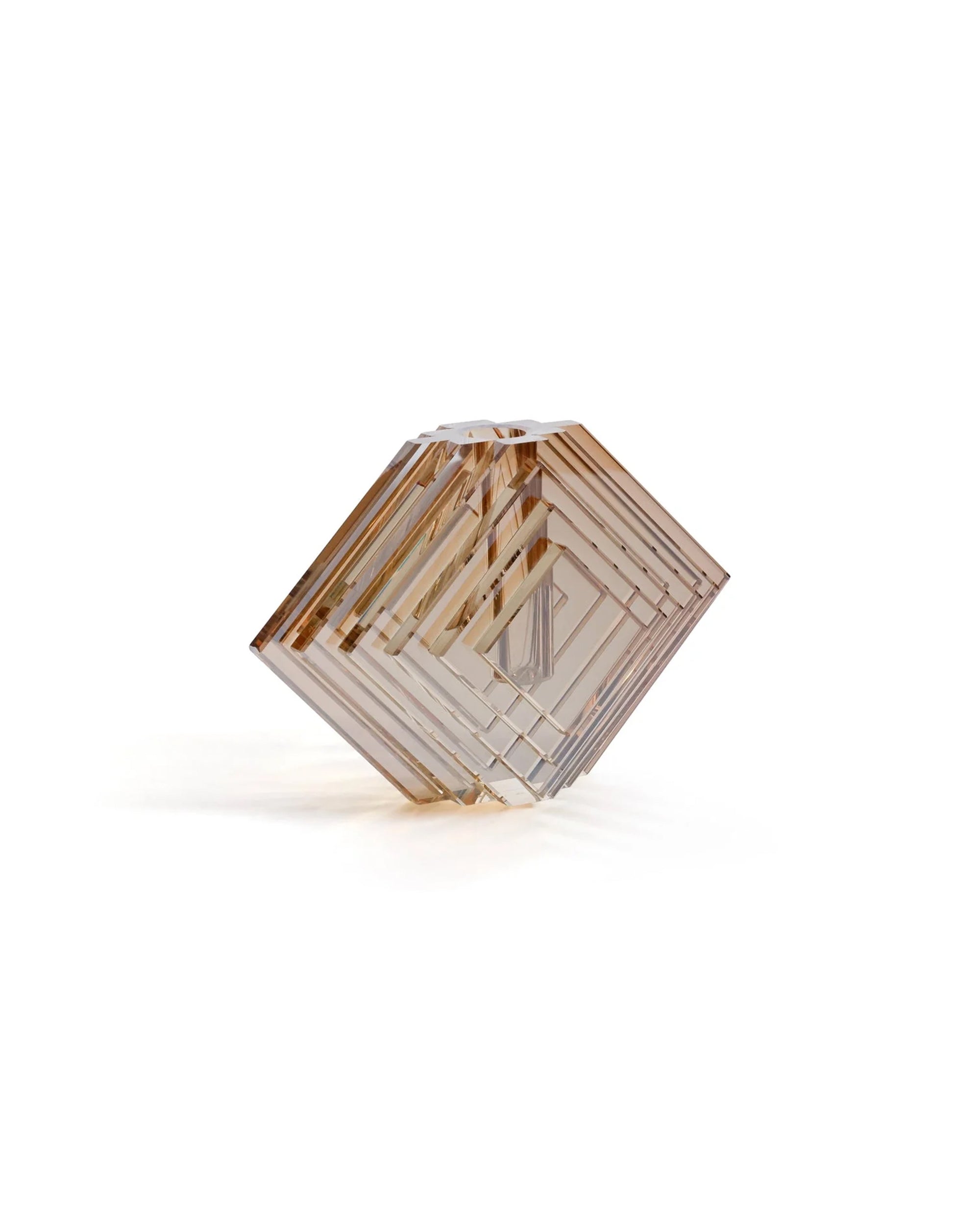 The Zodax CH-8148 Diamond Vase M features stacked, transparent square panels angled into a diamond form, creating a sculptural vase that casts subtle shadows on any white surface.