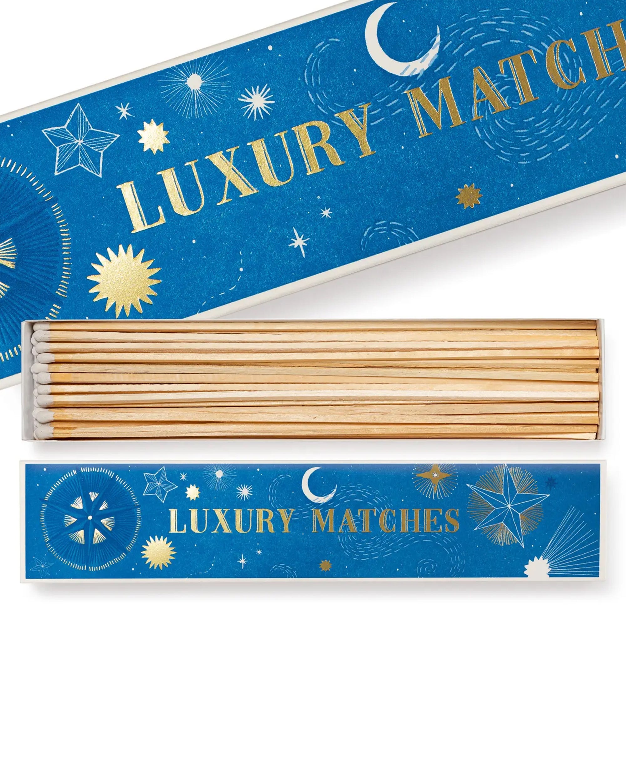 The Faire Starry Sky Long Matches come in a blue rectangular box with gold text and celestial designs, featuring gold and white stars and moons. Inside, extra long match sticks are neatly arranged.