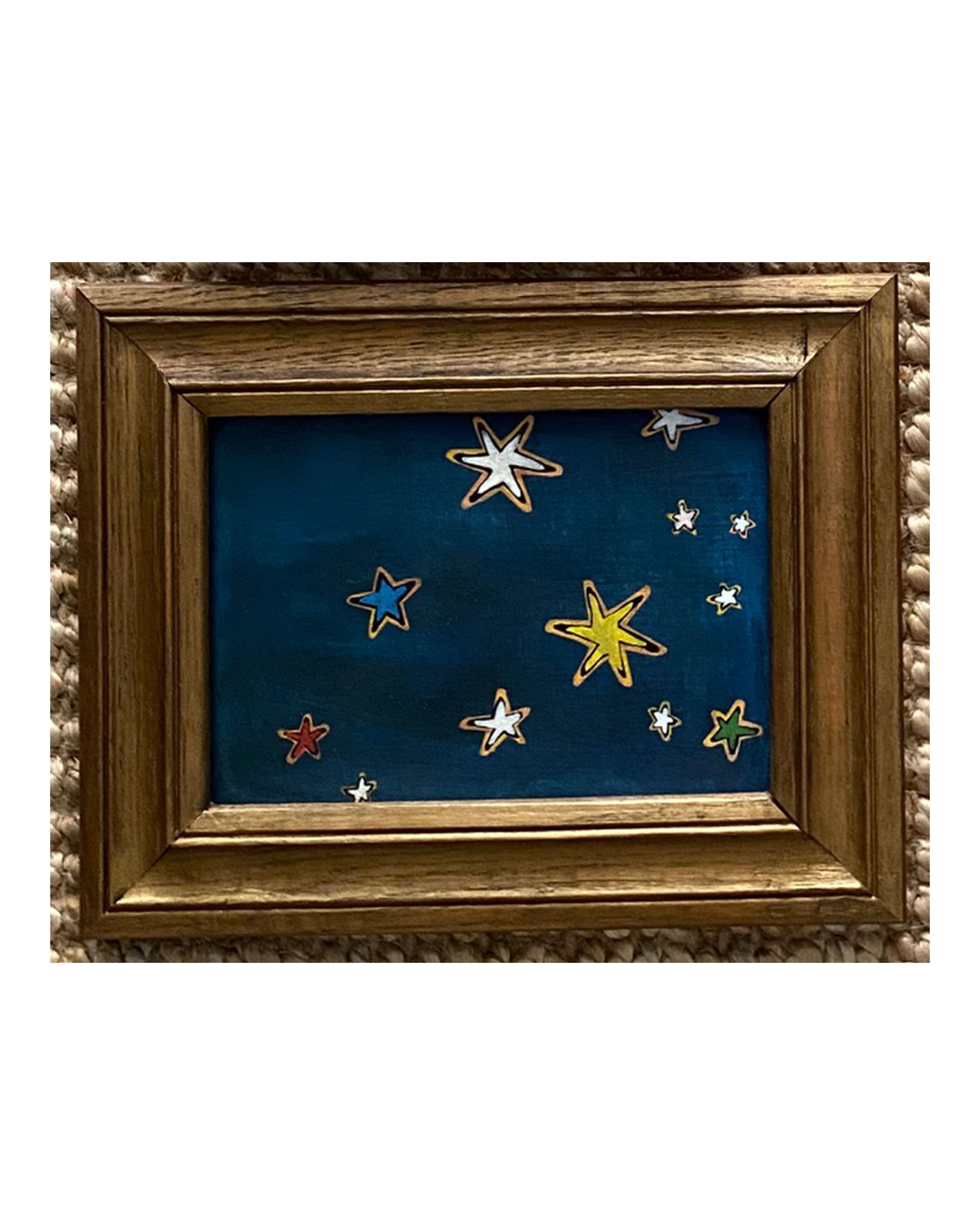 SKY &amp; STARS by Tak Design: A hand-painted artwork in vintage frames, featuring a dark blue night sky with white, yellow, and red stars of varying sizes on a textured background—crafted by a local artist.