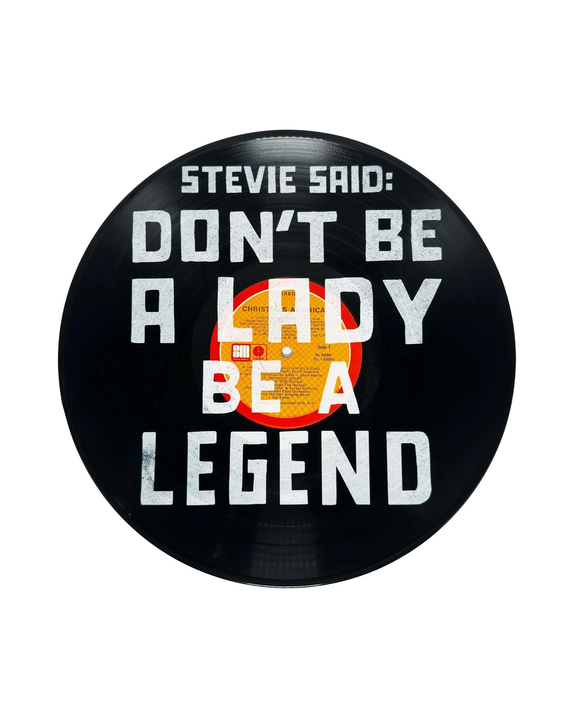 The Sugarboo Designs Stevie Said Vinyl Record features bold white text—"DON'T BE A LADY, BE A LEGEND"—on black, making striking wall decor for any space.