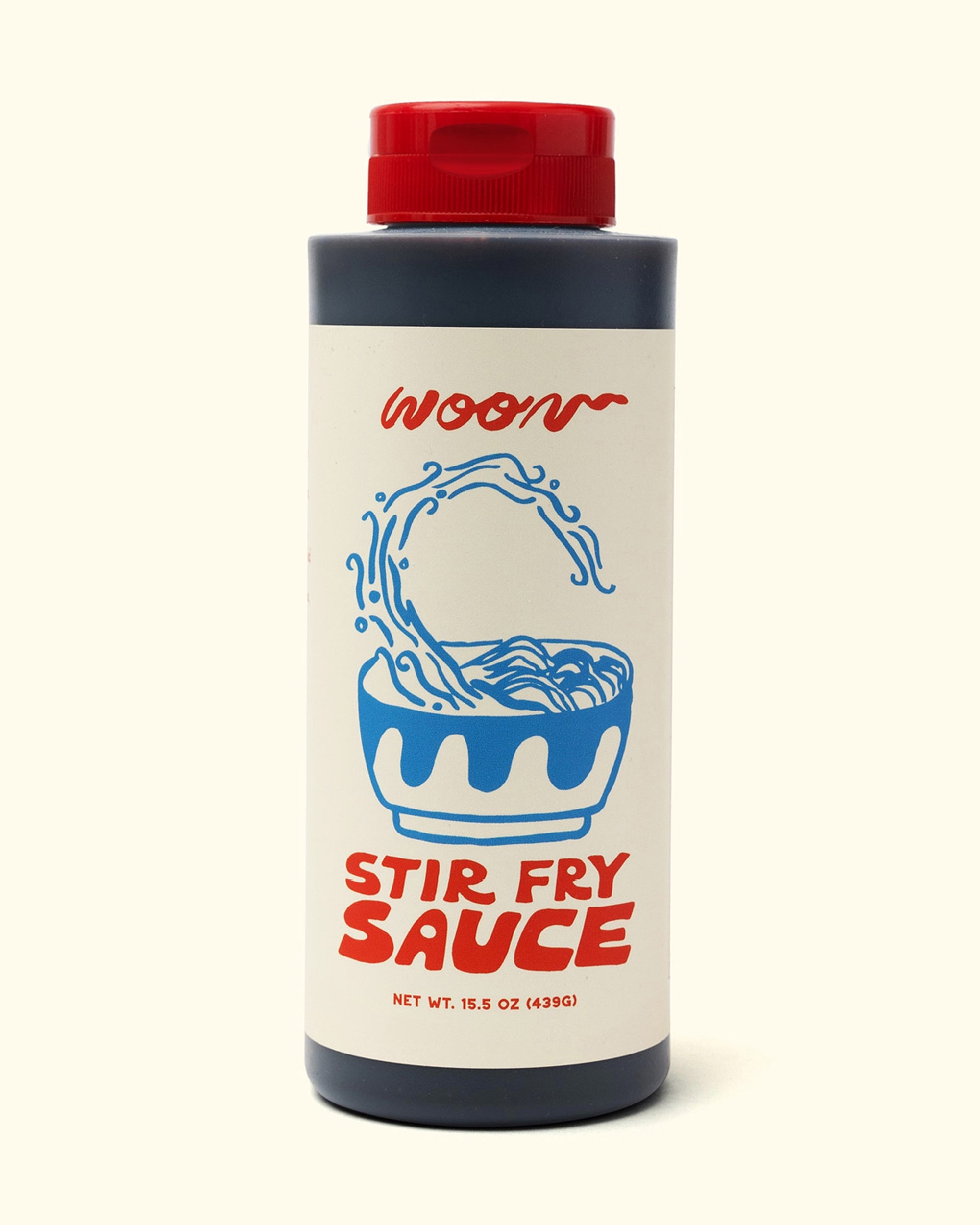 A 15.5 oz bottle of Faire’s Woon Stir Fry Sauce with a red cap, blue noodle bowl illustration, and red “WOON” and “STIR FRY SAUCE” text on the label. Gluten-free cooking sauce.