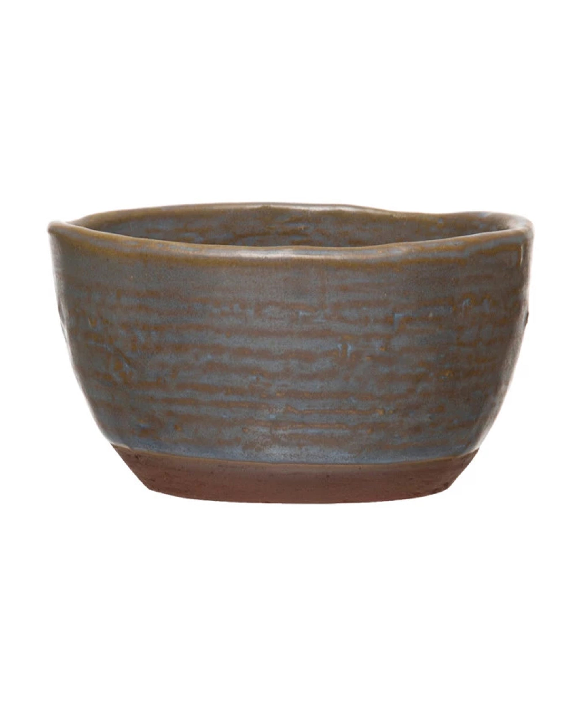 The DF4964 Stoneware Bowl by Creative Co-op features a textured, matte grayish-blue finish, a slightly uneven rim, and a reddish-brown base, creating a rustic, artisanal look—ideal as a unique gift for the kitchen.