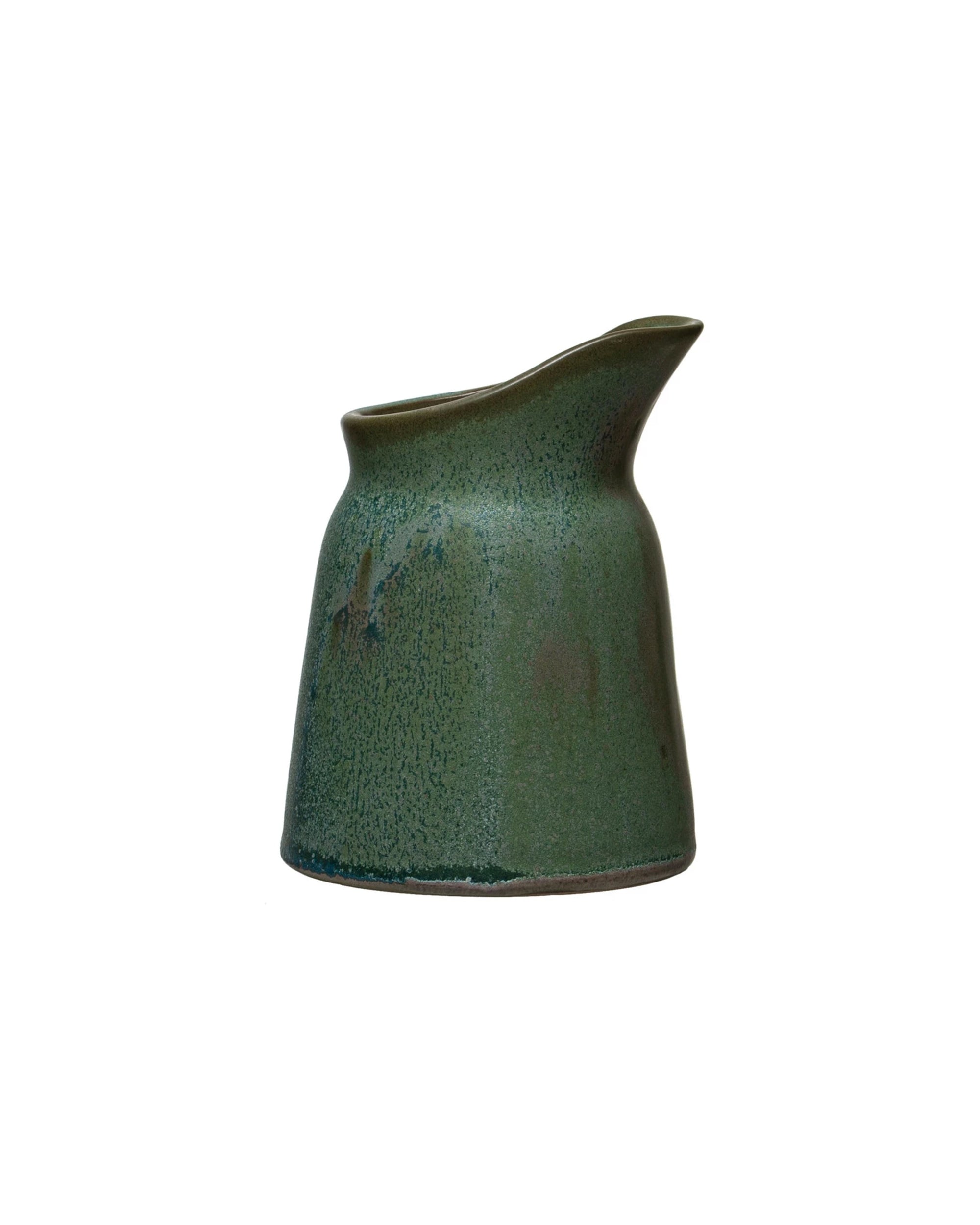 The Creative Co-op DF6763 Stoneware Creamer is a small green vessel with a wide base, narrow top, and spouted lip, featuring a reactive glaze and displayed against a white background.