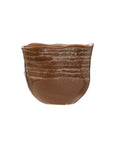 The Creative Co-op AH2781 Stoneware Planter features a handcrafted brown design with an uneven rim, textured horizontal patterns, and a reactive glaze, displayed against a plain white background.