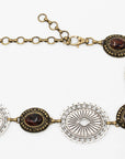 The Brass & Silver Concho by Streets Ahead Inc is a vintage-style necklace with alternating oval silver filigree and dark brown gemstones, joined by a mixed metal brass chain and clasp, shown on a white background.