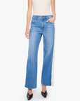 Mother’s The Striped Resealable Skimp jeans styled with a white top and black shoes, casual modern look.