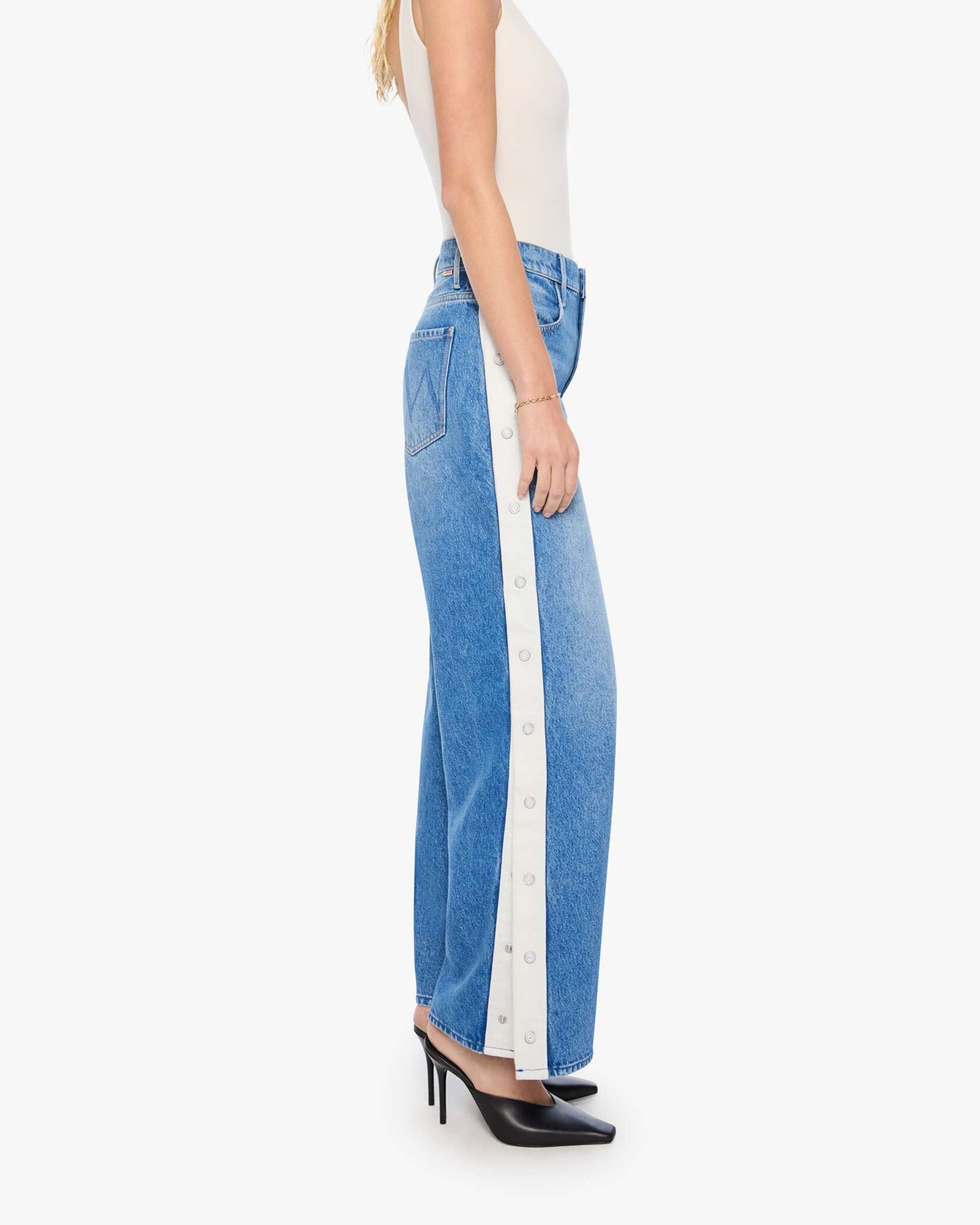 The Striped Resealable Skimp jeans by Mother in blue-white stripe, styled with a white top and black heels.