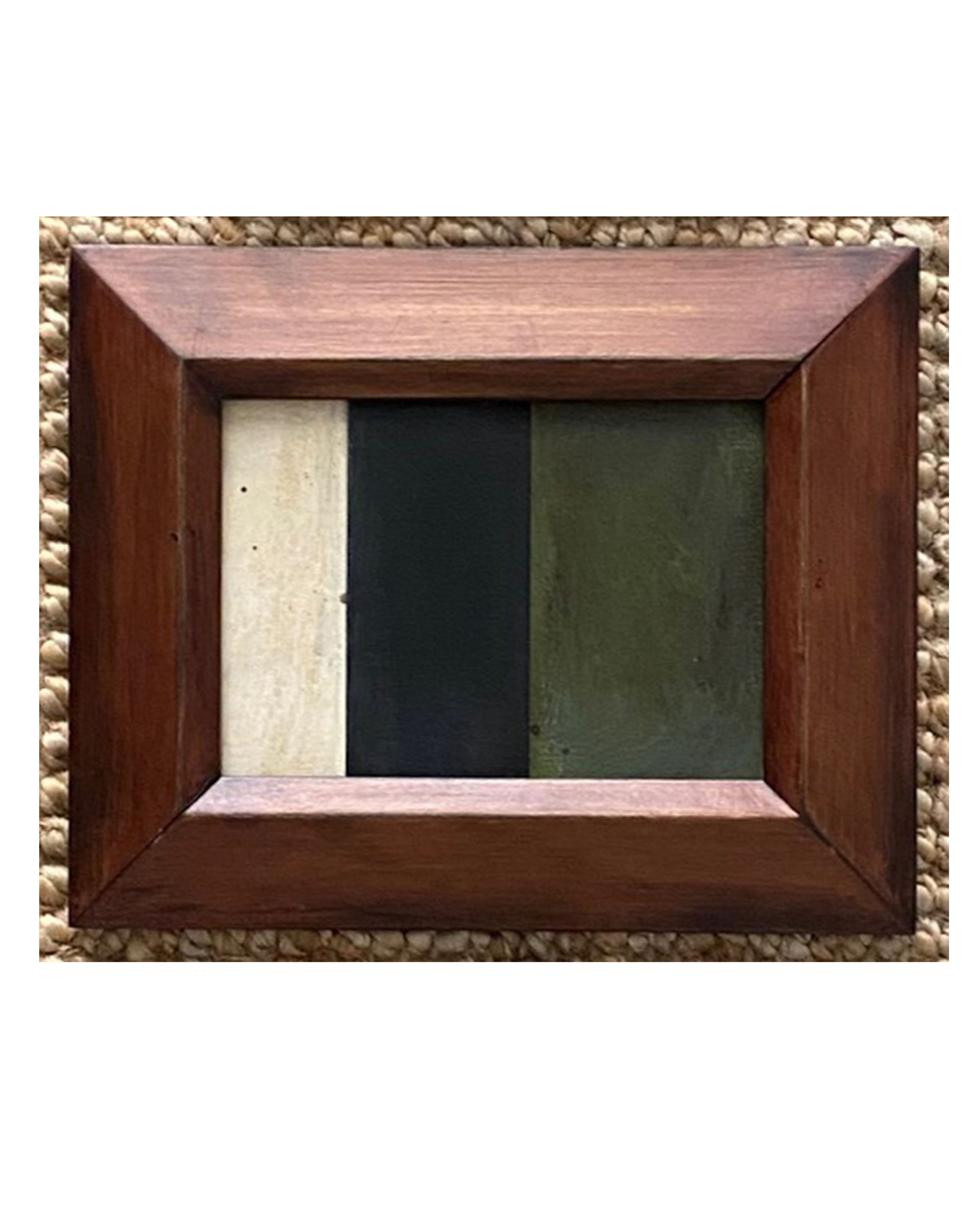The STRIPES Framed Art by Tak Design is a unique hand-painted abstract piece featuring three vertical sections in cream, dark green, and olive, set in a wide wooden frame and displayed on a textured surface.