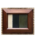 The STRIPES Framed Art by Tak Design is a unique hand-painted abstract piece featuring three vertical sections in cream, dark green, and olive, set in a wide wooden frame and displayed on a textured surface.