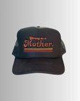 The Retro Mother Hat by Faire channels a retro mom vibe with its black mesh, "Strong as a Mother." in orange and brown above three stripes, set against a light gray to white gradient background.