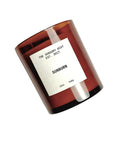 A brown glass jar labeled "Faire SUNBURN 12 oz" sits on a white background, featuring a clean burning scented soy wax candle.