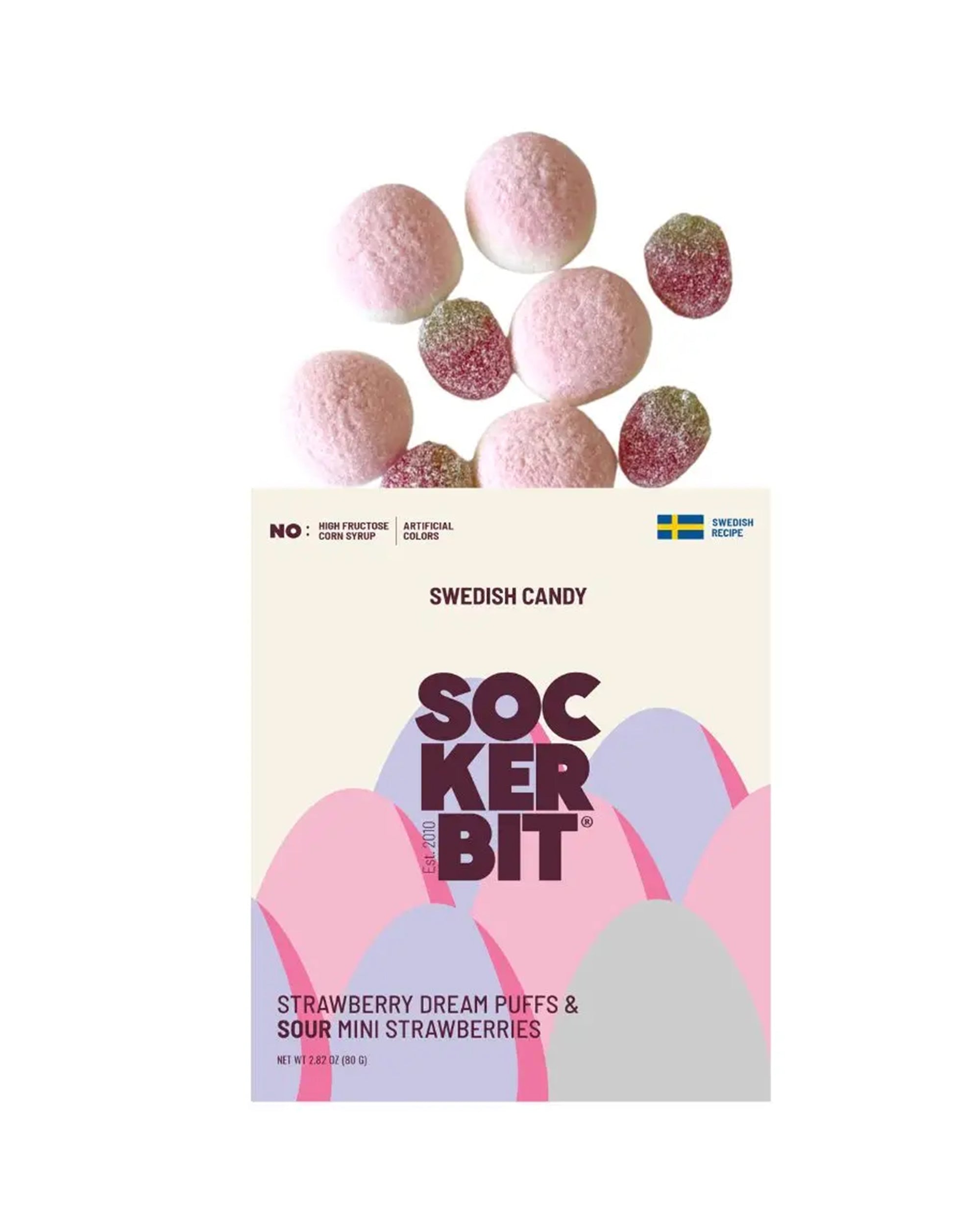 A bag of Faire Sweet & Sour Strawberry candy, featuring a pastel pink and purple design, with foamy strawberry bites spilling out above the bag.